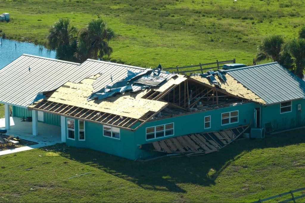 House with severe roof damage after storm or hurricane