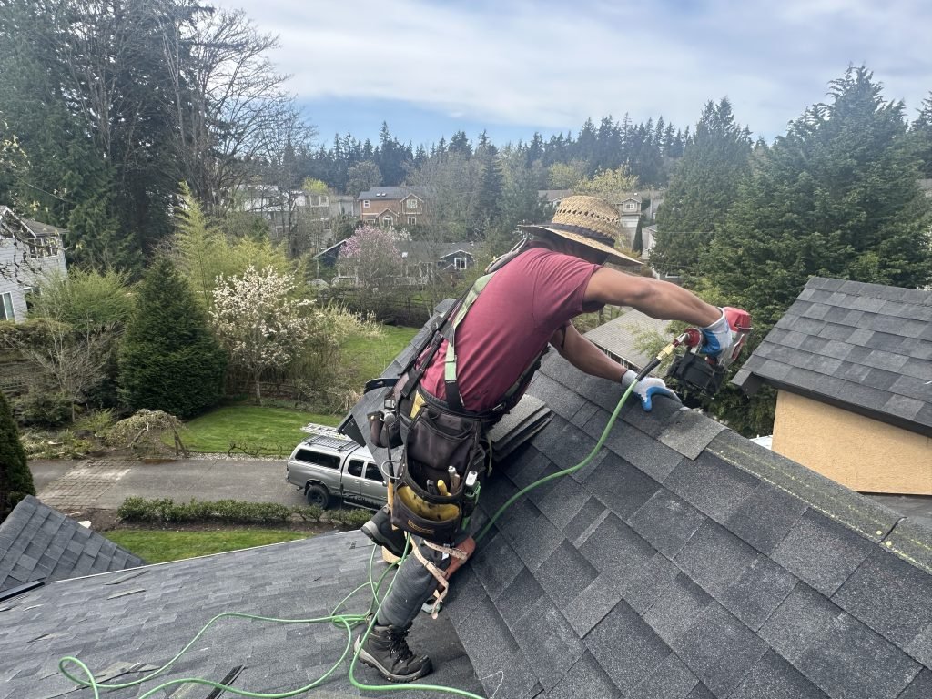 Man wearing safety harness working on roof installation