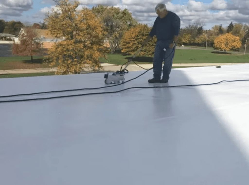 TPO roofing installation in progress with heat-welding machine