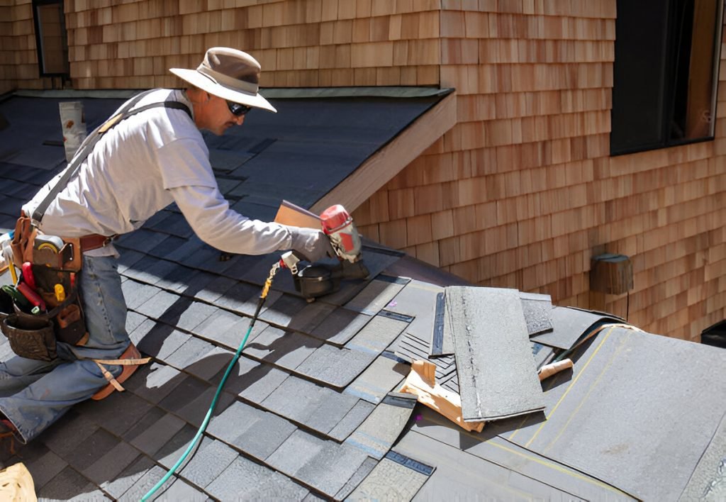 Man installing asphalt roof