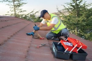 Roofer Construction Worker Replace Tile Of The Old Roof